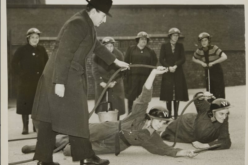 The first Women Fire-Fighters In Manchester - wardens receiving instruction in the use of the stirrup pump for extinguishing incendiary bombs; date not stated