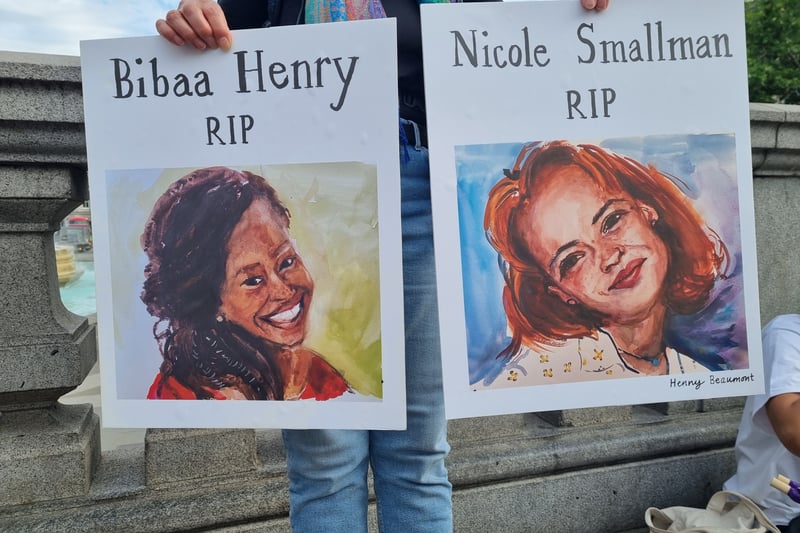 One protestor held paintings of the murdered sisters Bibaa Henry and Nicole Smallman.