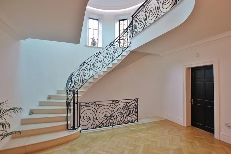 The extensive hallway leads you towards the stone winding staircase - with beautiful, intricate  bannister. 