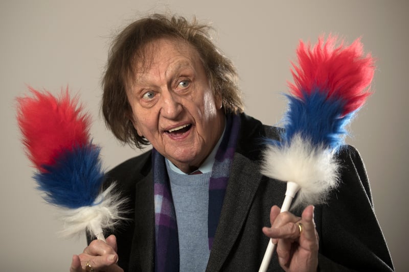 Sir Kenneth Dodd was an English comedian and singer known for his live stand-up performances. The late comedian was born in the Knotty Ash suburb of Liverpool and was a lifelong resident of the area until his death in 2018. He went to the Knotty Ash School and later attended Holt High School, a grammar school in Childwall, but left at 14 to work for his father, who was a coal merchant. It was around this time that he became interested in show business. 