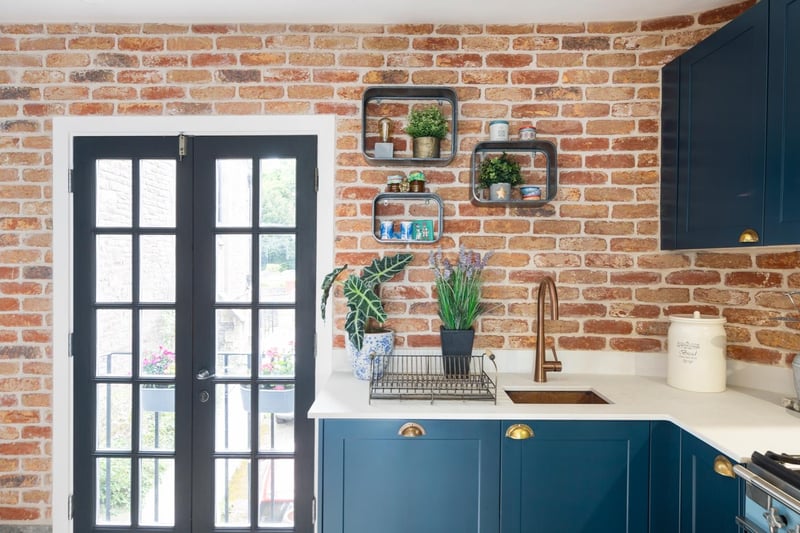 There are plenty of clever and unique design details throughout the property, with exposed brick walls adding a sense of style to the kitchen area
