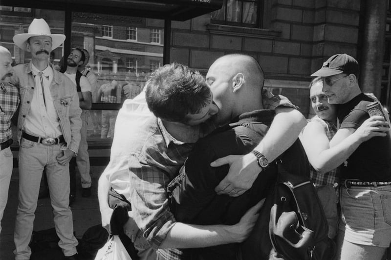 Male revellers hugging and kissing during the Gay Pride parade in London, England, United Kingdom, 6 July 1996. 