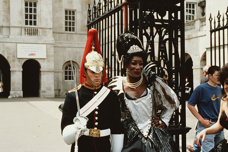 A cross-dresser having their picture taken with a member of the Household Cavalry at Buckingham Palace during Pride, London, 24th June 1995. 