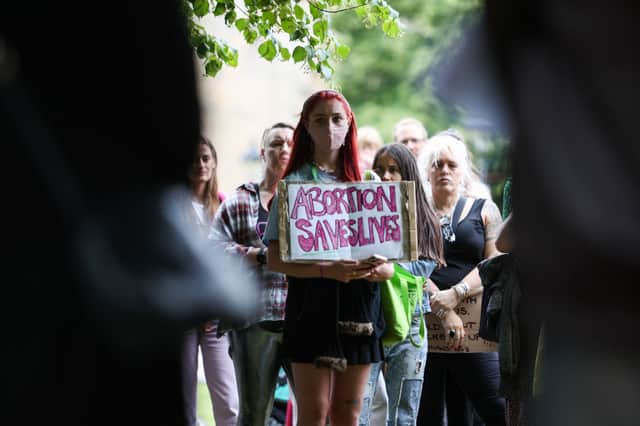 A woman holds a sign which reading ‘abortion saves lives’ at a pro-choice protest over the weekend in Bristol.