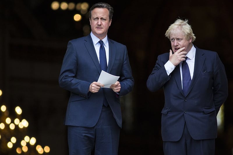 British Prime Minister David Cameron (L) and London Mayor Boris Johnson leave St Paul’s Cathedral in central London on July 7, 2015 after attending a memorial service in memory of the 52 victims of the 7/7 London attacks. 