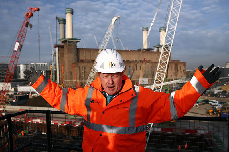 London Mayor Boris Johnson gestures as he poses for a photograph to mark the start of major works to build London Underground’s Northern line extension from Kennington to Battersea via Nine Elms at Battersea Park on November 23, 2015.