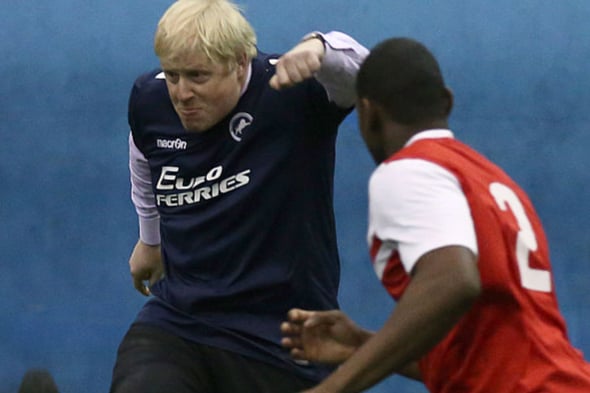 London mayor Boris Johnson takes part in a game of football during a visit to the Millwall Football Club Community Trust on January 14, 2015.