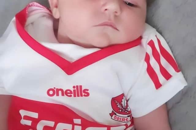 Three weeks old Alara Grace Divin wearing her Derry colours 