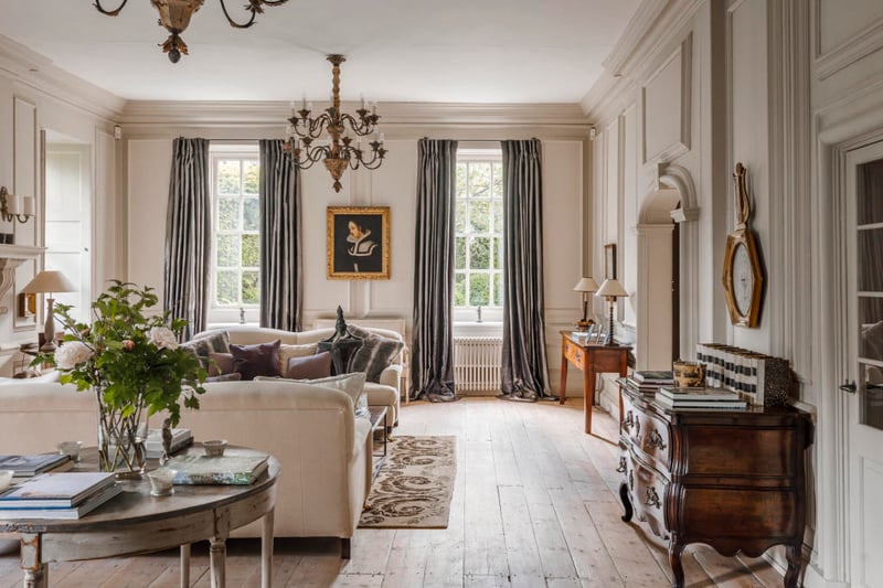 On the right of the hallway is the reception room, which overlooks the gardens. Four large sash windows flood the space with light, and there is direct access to gardens through French doors.
