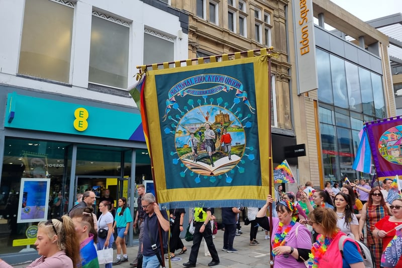 Newcastle Education Union carry a flag.