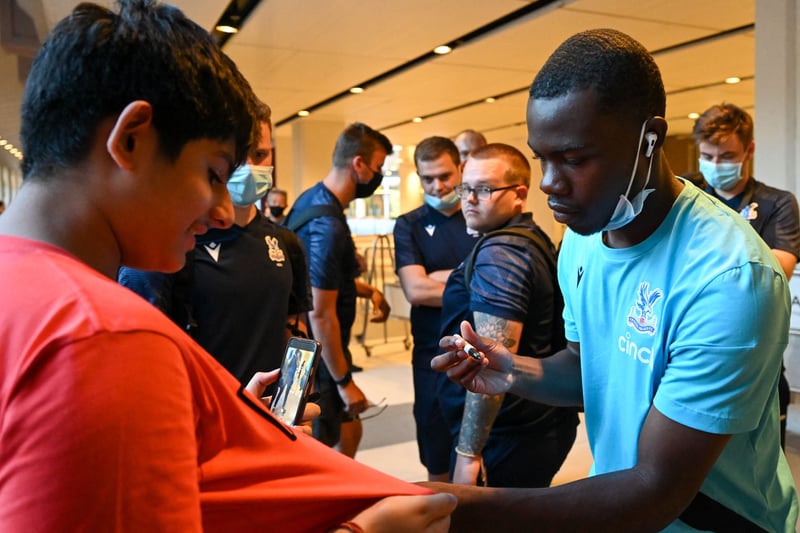 Crystal Palace FC player Tyrick Mitchell signs autographs for a fan upon arrival at Changi International Airport in Singapore.