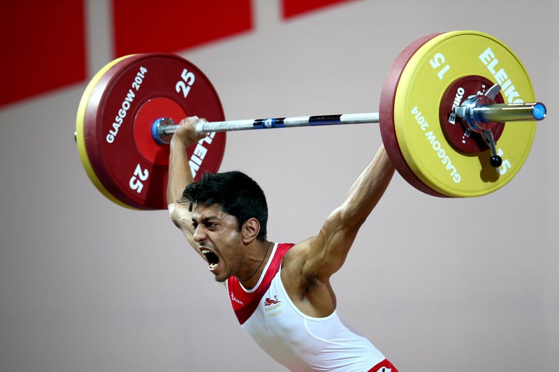 Jaswant Shergill of England makes a lift as he competes in the Men's 62kg Group B Weightlifting at the Scottish Exhibition And Conference Centre during day two of the Glasgow 2014 Commonwealth Games