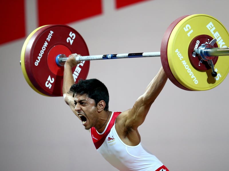Jaswant Shergill of England makes a lift as he competes in the Men's 62kg Group B Weightlifting at the Scottish Exhibition And Conference Centre during day two of the Glasgow 2014 Commonwealth Games