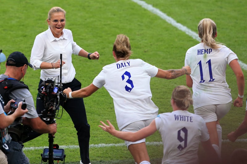 England’s coach Sarina Wiegman (L) celebrates with her team.