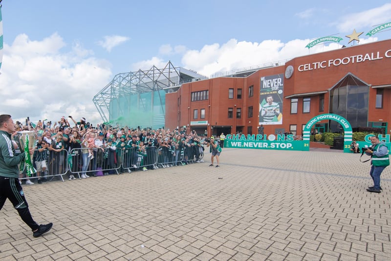 Celtic captain Callum McGregor arrives with the Scottish Premiership trophy in his grasp