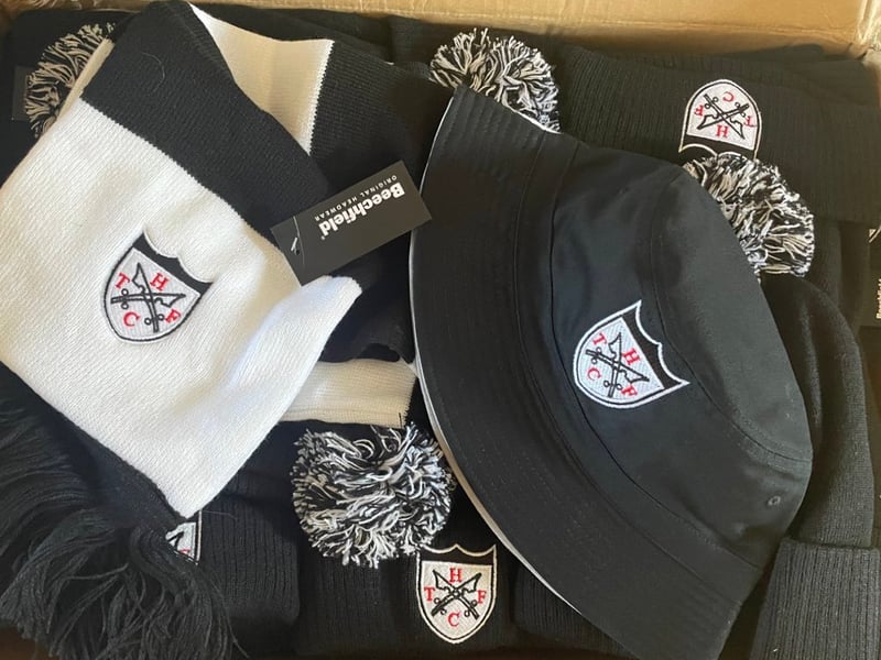 Given the black and white colours, Newcastle United fans love making purchases from the Hanwell Town club shop. As well as the kit, there are Brown Ale t-shirts, hats, beanies, badges, face coverings and more.