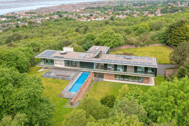 The building, named Rockmount, is an unusual and linear layout making it even more astonishing. The home boasts exceptional views, six bedrooms and an outdoor pool. It is a private area with a lot of space and minimal noise.