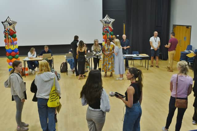 Students and parents nervously await their children collecting their results at Nene Park Academy.