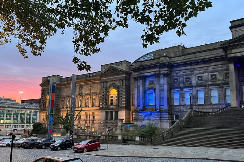 Liverpool World Museum lit up in yellow and blue in solidarity.