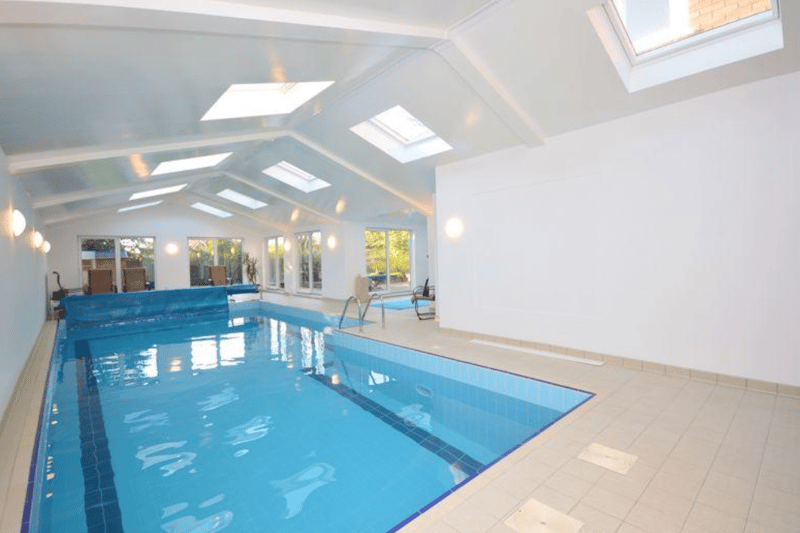 Inside, there’s a large pool area, with large windows overlooking the garden.