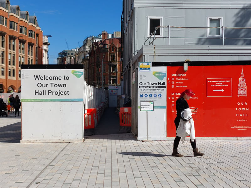 The multi-storey portacabin structure in the centre of the square houses the project headquarters. Credit: Sofia Fedeczko/Manchester World