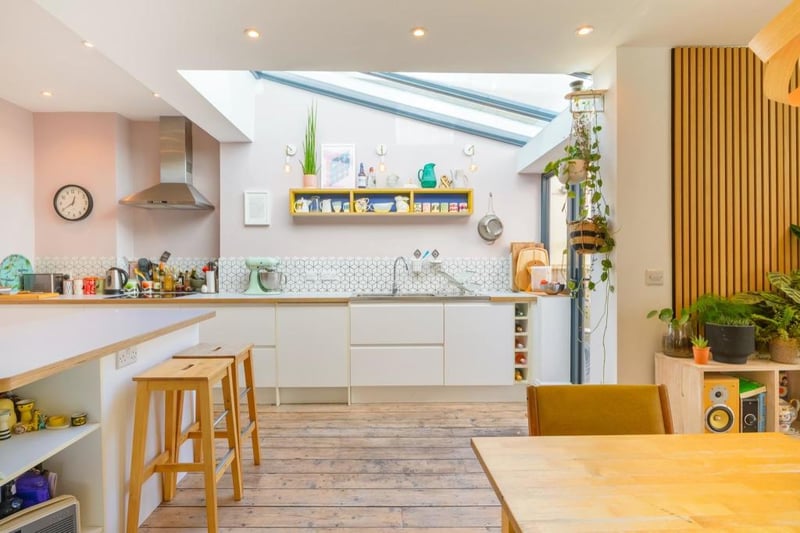 The modern kitchen extension perfectly blends old and new and uses interesting design features such as this wooden cladding on the wall