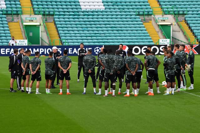 Real Madrid’s Italian coach Carlo Ancelotti (rear L) speaks to his players as he leads a team training session at Celtic Park