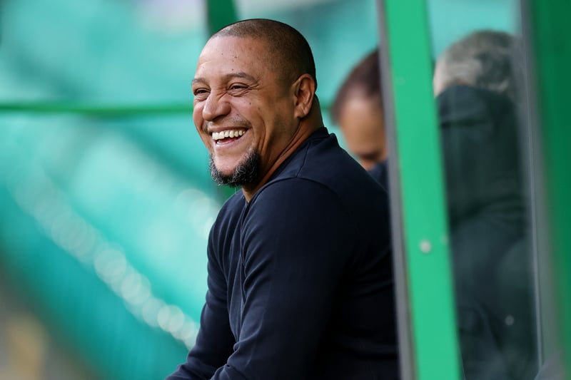 Ex-Real Madrid star Roberto Carlos watches on from the dugout at Celtic Park