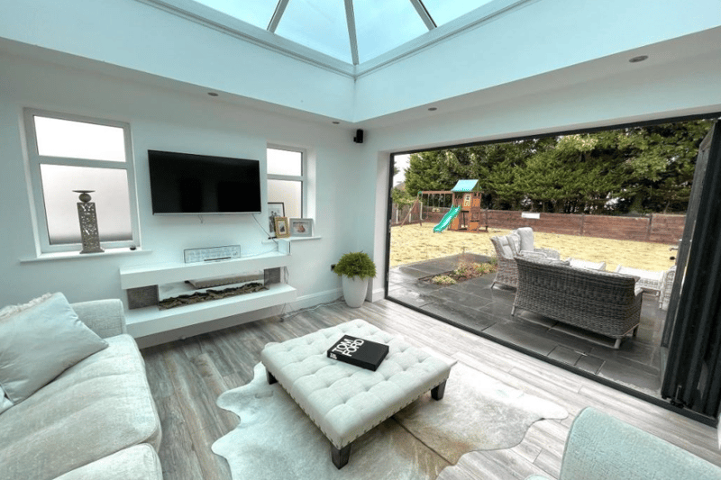 The spacious conservatory area has tons of natural light and opens on to the large garden, with a patio area.