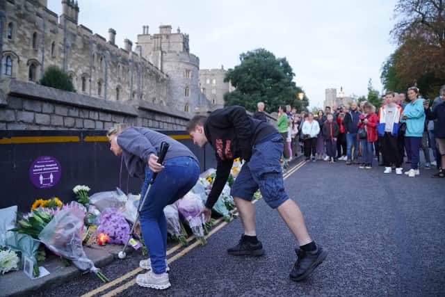 Mourners gather laying flowers outside Windsor Castle in Berkshire following the announcement of the death of Queen Elizabeth II. Picture: PA.