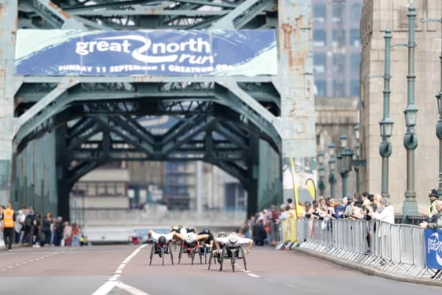 Elite wheelchair athletes pass over the Tyne Bridge during the Great North Run. Picture: PA.