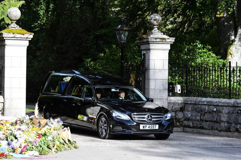The hearse carrying the coffin of Queen Elizabeth II is driven away from Balmoral Castle in Ballater.