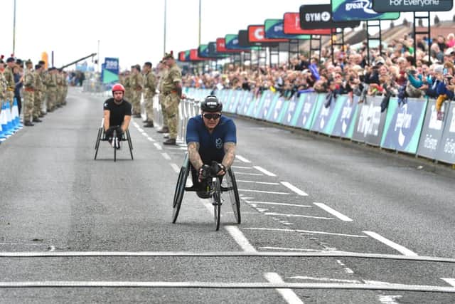 The winner of the Great North Run’s wheelchair race crosses the finish line in South Shields.