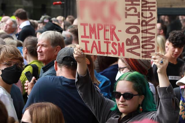 A protester holds up a sign at the proclaimation of the new King in Edinburgh. It reads: “F***IMPERIALISM, ABOLISH MONARCHY" (SWNS)