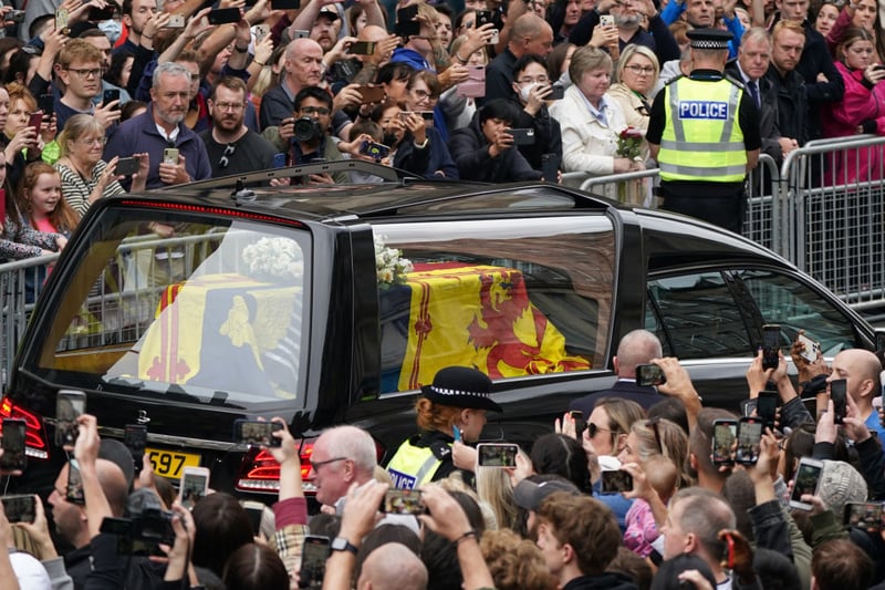 Large crowds gather to watch the hearse carrying the coffin of the late Queen Elizabeth II pass by in Edinburgh 