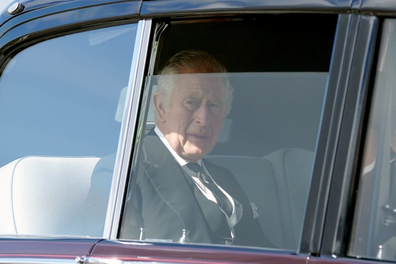 King Charles III and the Queen Consort leave Edinburgh Airport by car after travelling from London, ahead of joining the procession of Queen Elizabeth’s coffin.