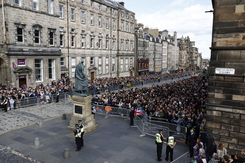 Crowds line both sides of the Royal Mile ahead of the procession.