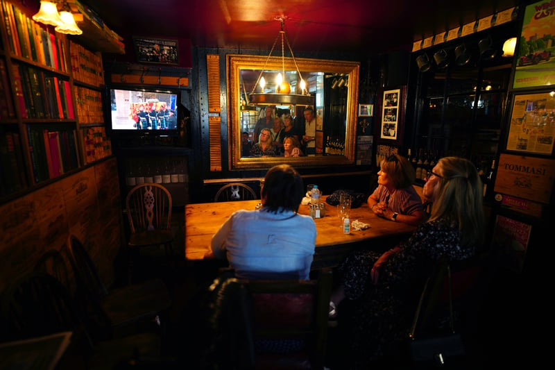 People in The Two Brewers pub in Windsor, Berkshire, watching on a television King Charles III joining the procession of Queen Elizabeth II coffin from the Palace of Holyroodhouse to St Giles’ Cathedral