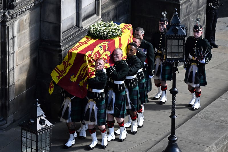 Pallbearers carry the coffin of Queen Elizabeth II, draped in the Royal Standard of Scotland, into St Giles’ Cathedral