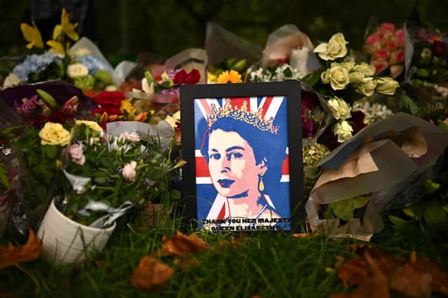 A pop-art inspired image of the Queen surrounded by flowers is among the floral tributes laid in Green Park.