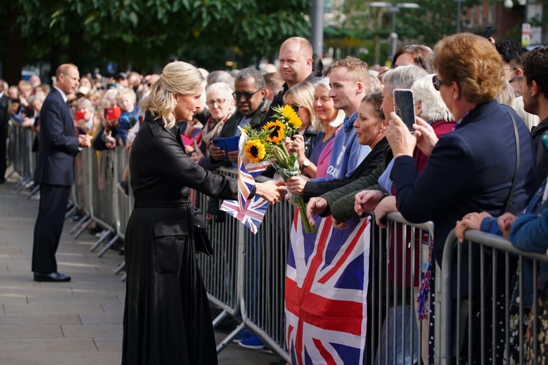 Prince Edward and Sophie talk to people in the crowd outside Manchester Central Library Credit: PA