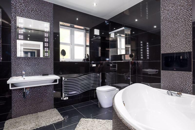 The striking main bathroom has a huge tub for relaxing in