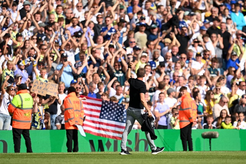 A fan brings an American flag in support of the manager at Elland Road. 
