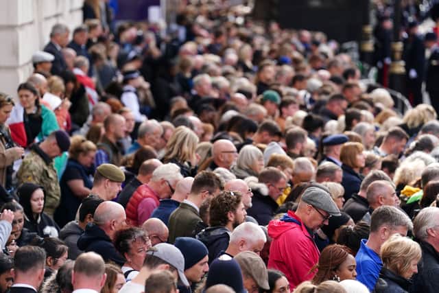 Crowds listen to the service on Horse Guards Avenue on Monday. Picture: PA.