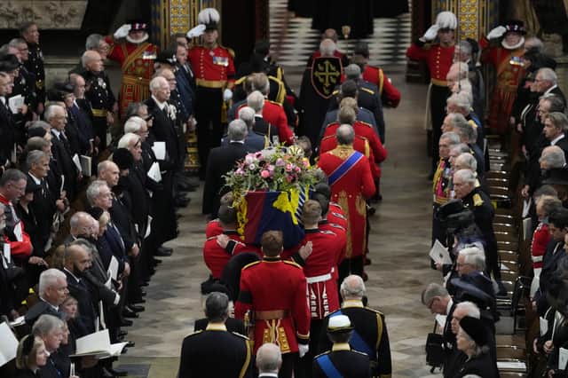 The coffin of Queen Elizabeth II is carried into Westminster Abbey for her funeral in central London. Picture date: Monday September 19, 2022.
