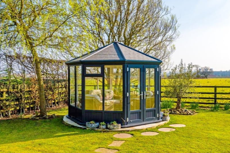 The small conservatory is cosy and perfect for a cup of tea with guests. 