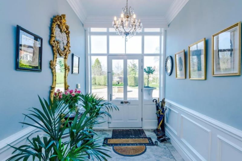 The entrance hallway is a perfect mix of classic and modern, with beautiful light fixtures and modern flooring.
