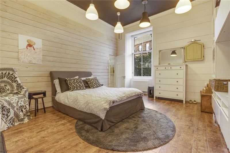 One of the bedrooms in the home, the bespoke wooden floors can be seen in this photo.