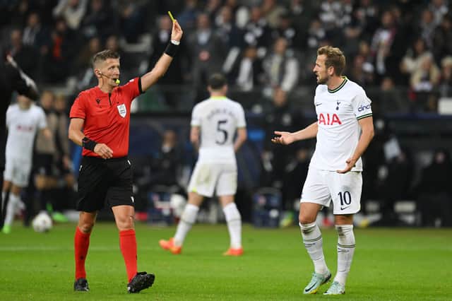 Harry Kane of Tottenham Hotspur reacts after being shown a yellow card by referee (Photo by Matthias Hangst/Getty Images)