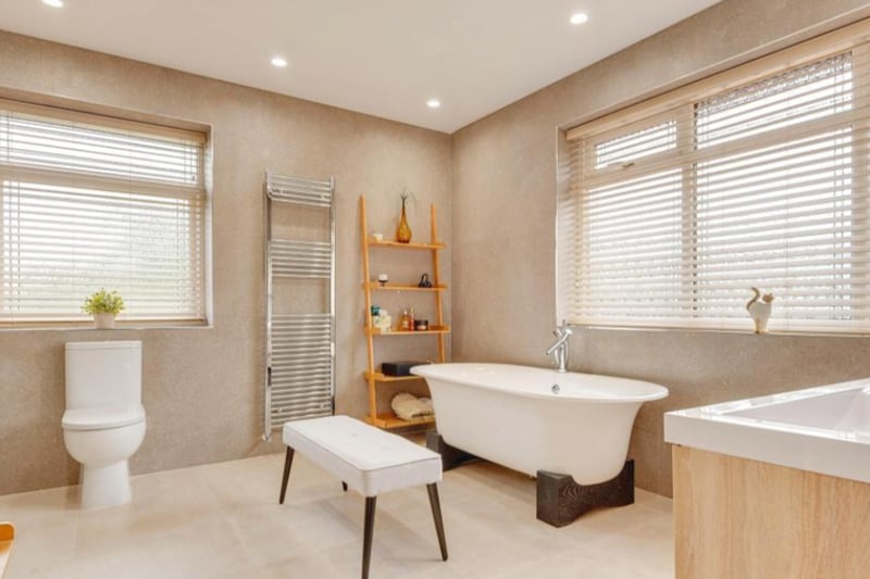 The family bathroom features a beautiful free-standing bath tub.